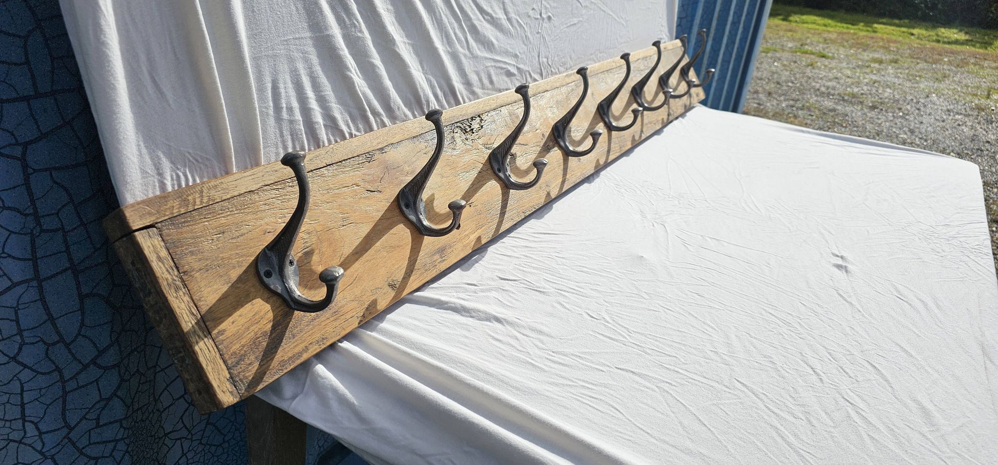 Teak coat rack with 8 double cast iron hooks