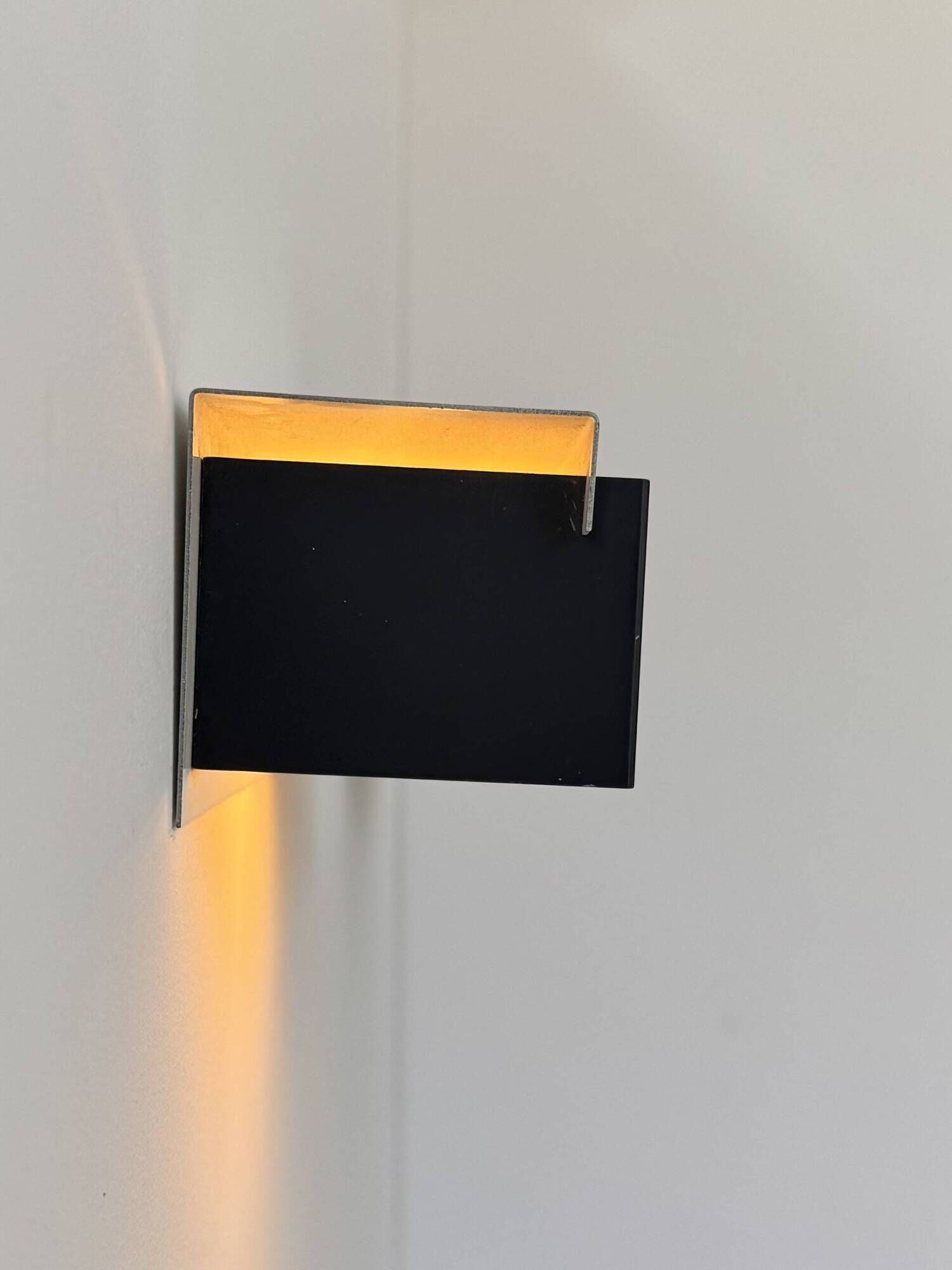 Pair of vintage wall sconces, painted black and white metal, Sweden 1970.