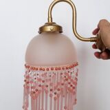 Pink glass wall lamp with garland of pearls