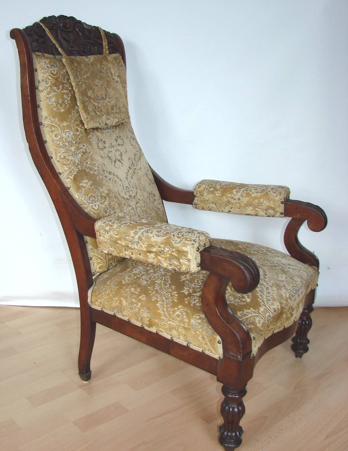 An antique armchair from the turn of the 19th and 20th centuries, carved wa
