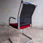 Set of 4 cantilever chairs with burgundy seat and mesh backrest.