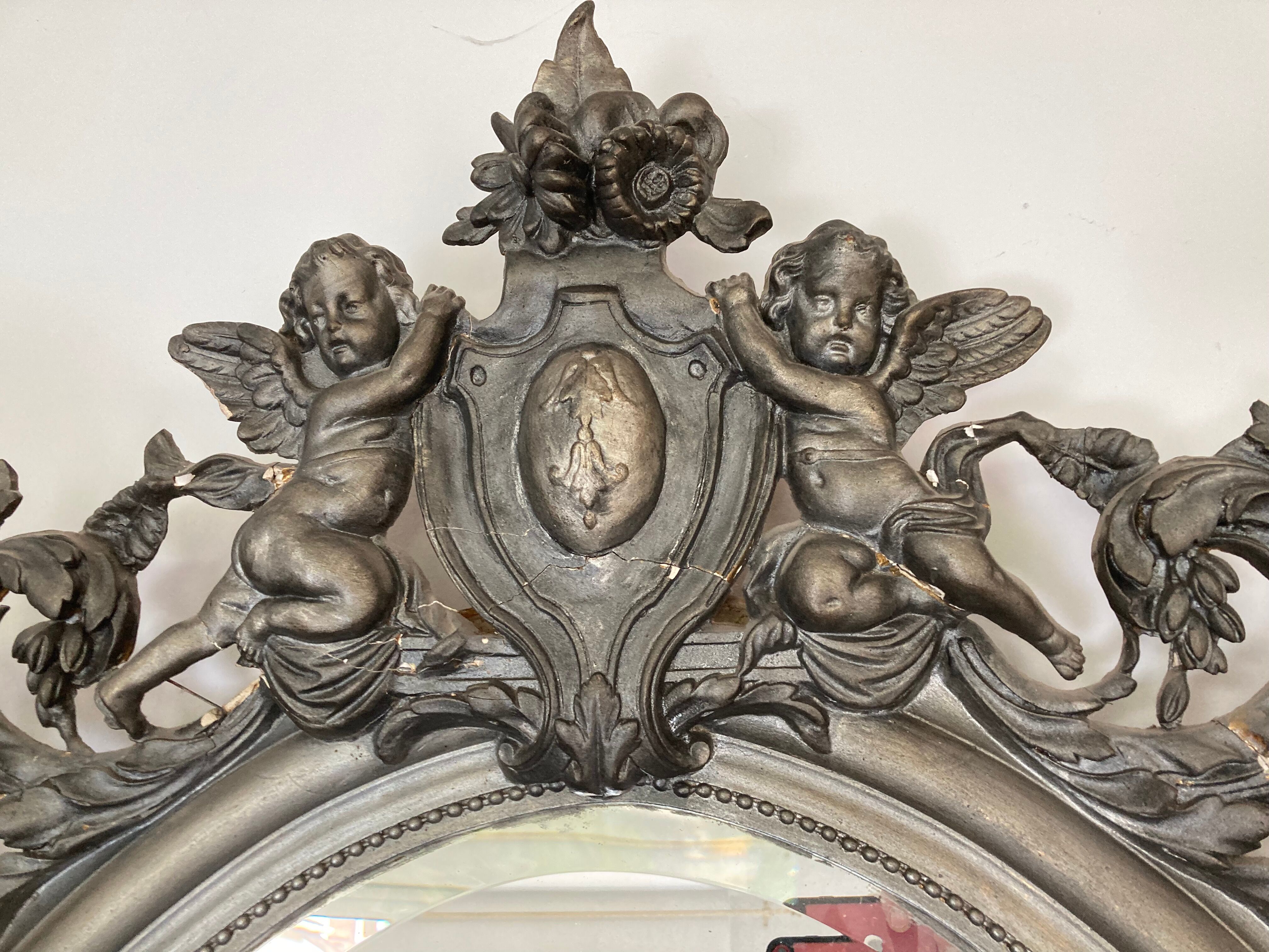 Miroir ovale biseaute  en bois et stuc