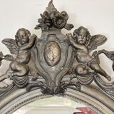 Beveled oval mirror in wood and stucco