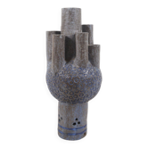 Ceramic sculpture with circular patterns and signature