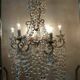 A pair of imposing, antique chandeliers with pendants.