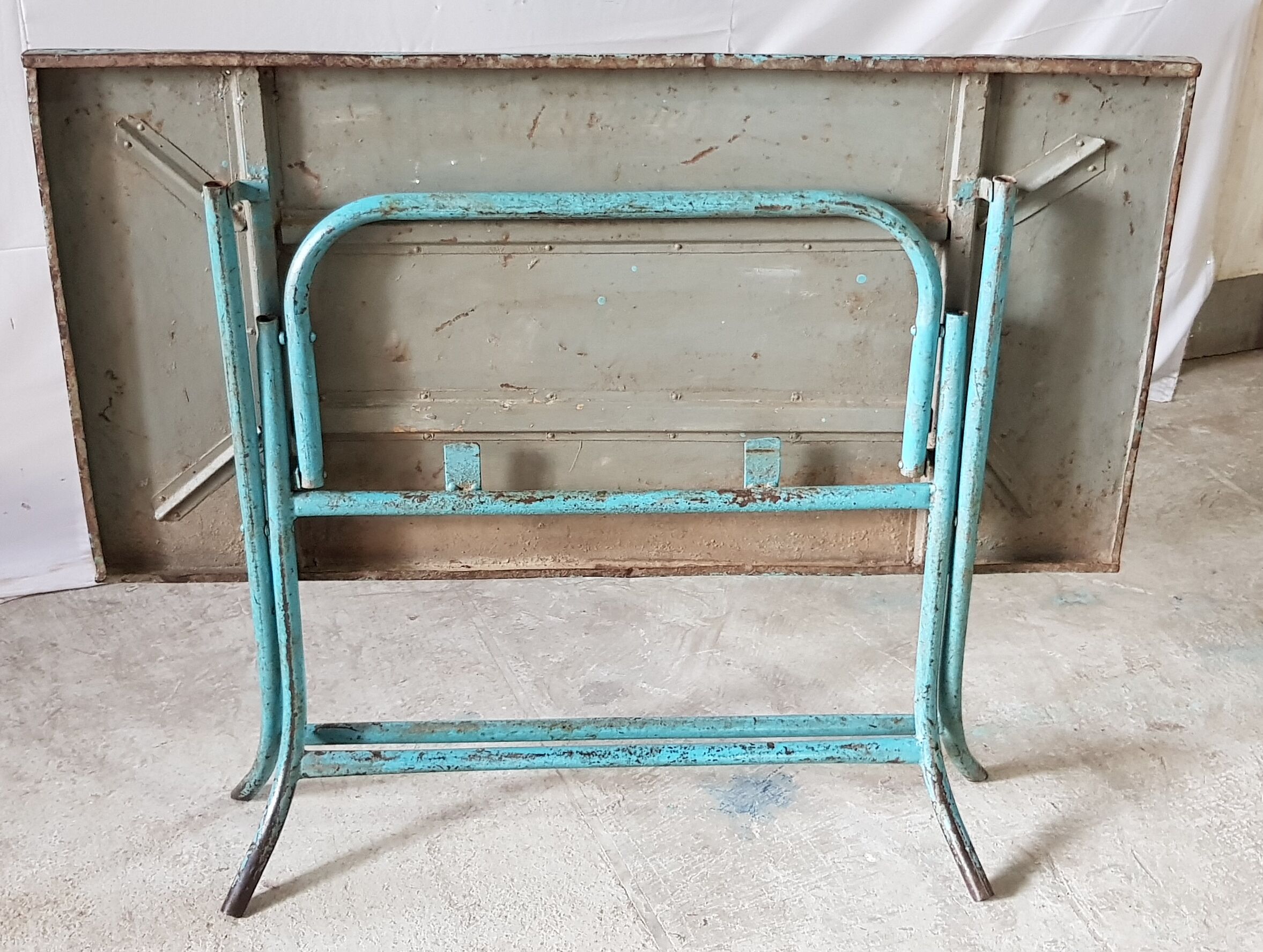Old metal folding table with its original turquoise patina