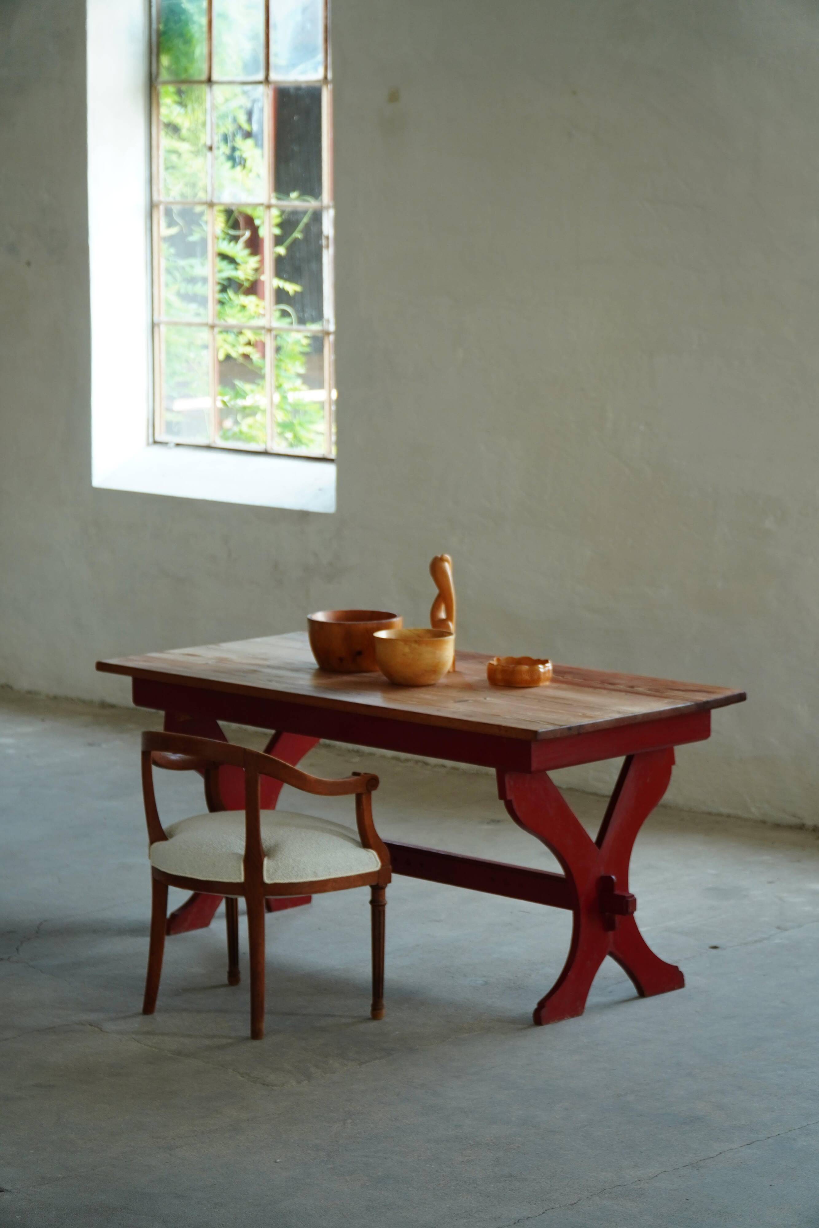 Rustic farmhouse dining table in painted red pine, Sweden, 1920s.