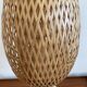 Design lamp in gold metal and wicker