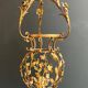Important golden iron lantern with foliage decorations from the Baguès house.
