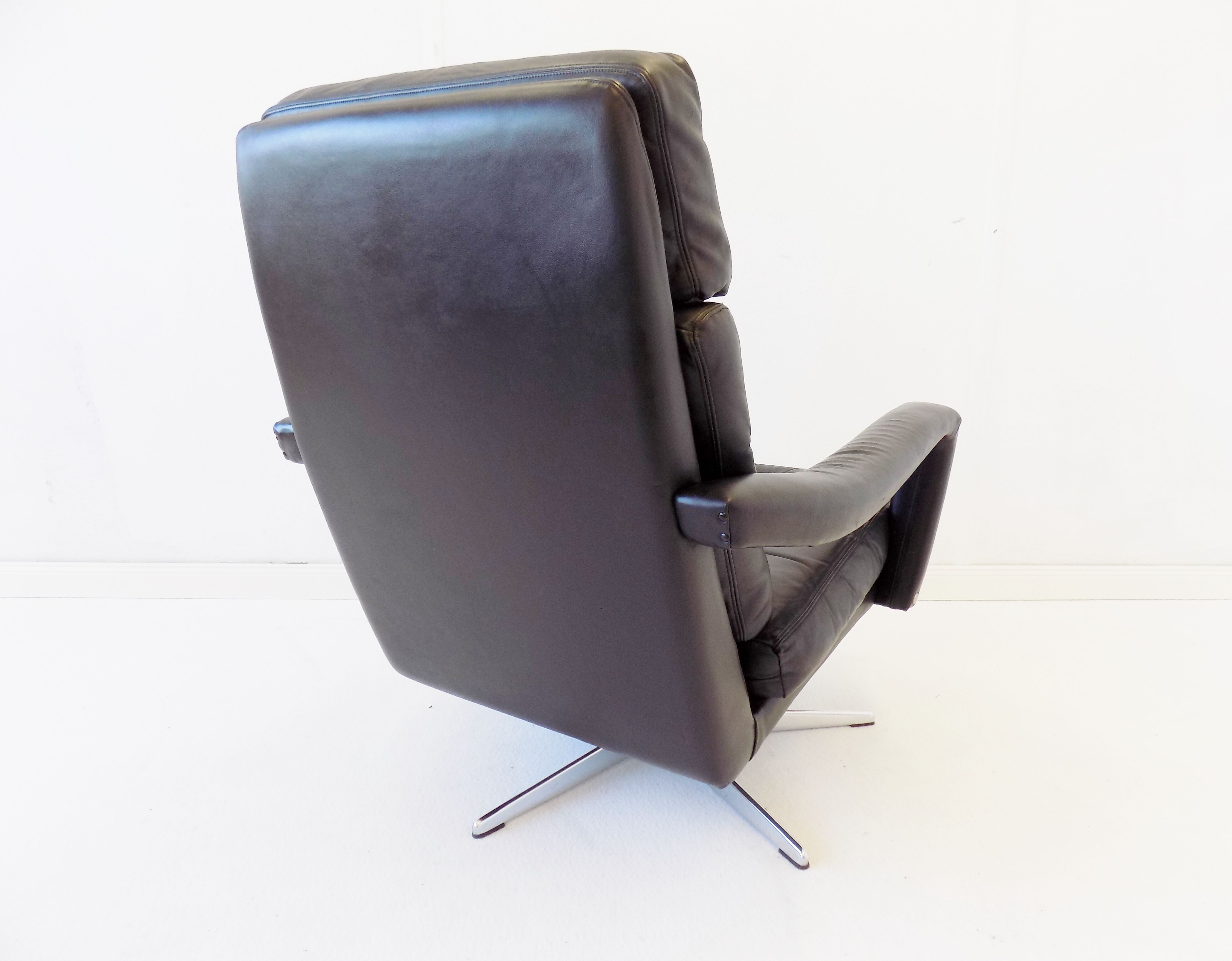 Danish black leather armchair with ottoman 70s