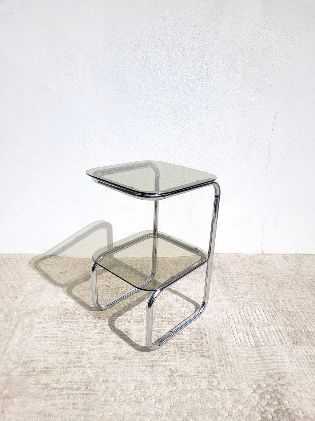 Vintage 1970s side table in chrome metal and smoked glass.
