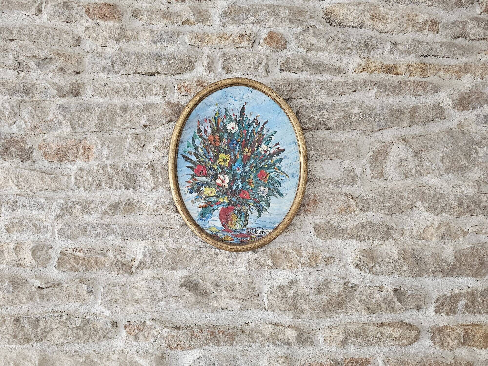 Oil painting on panel of a bouquet of colourful flowers in a vase, signed Valota.