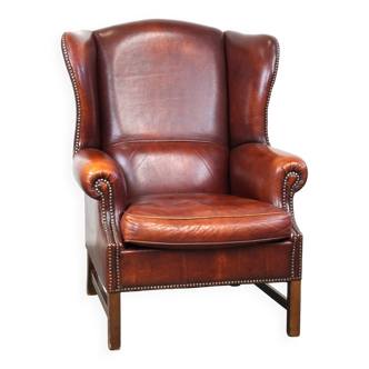 Grand fauteuil à oreilles confortable en cuir de mouton en bon état et belles couleurs