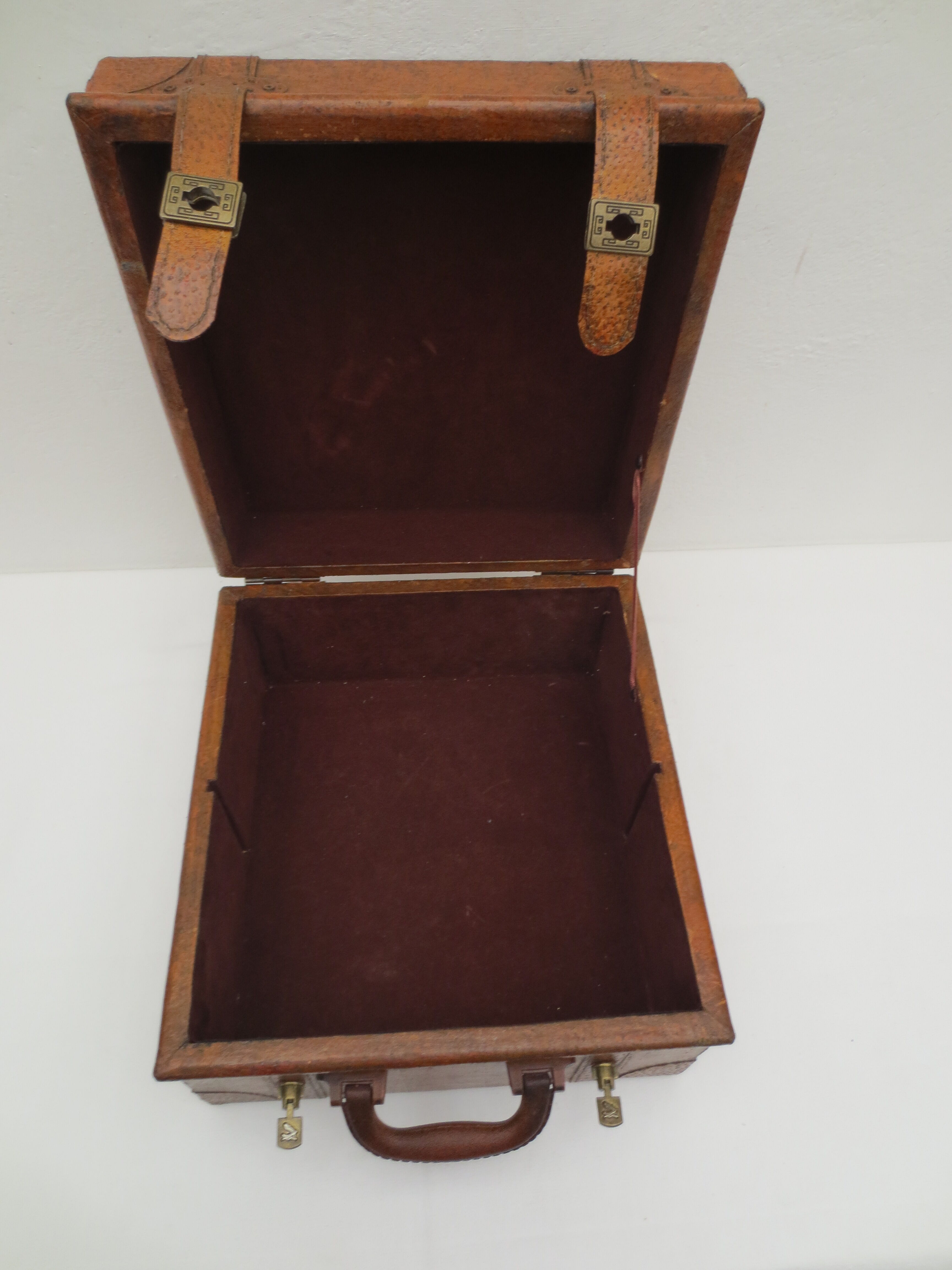 Rectangular wooden suitcase covered with leather