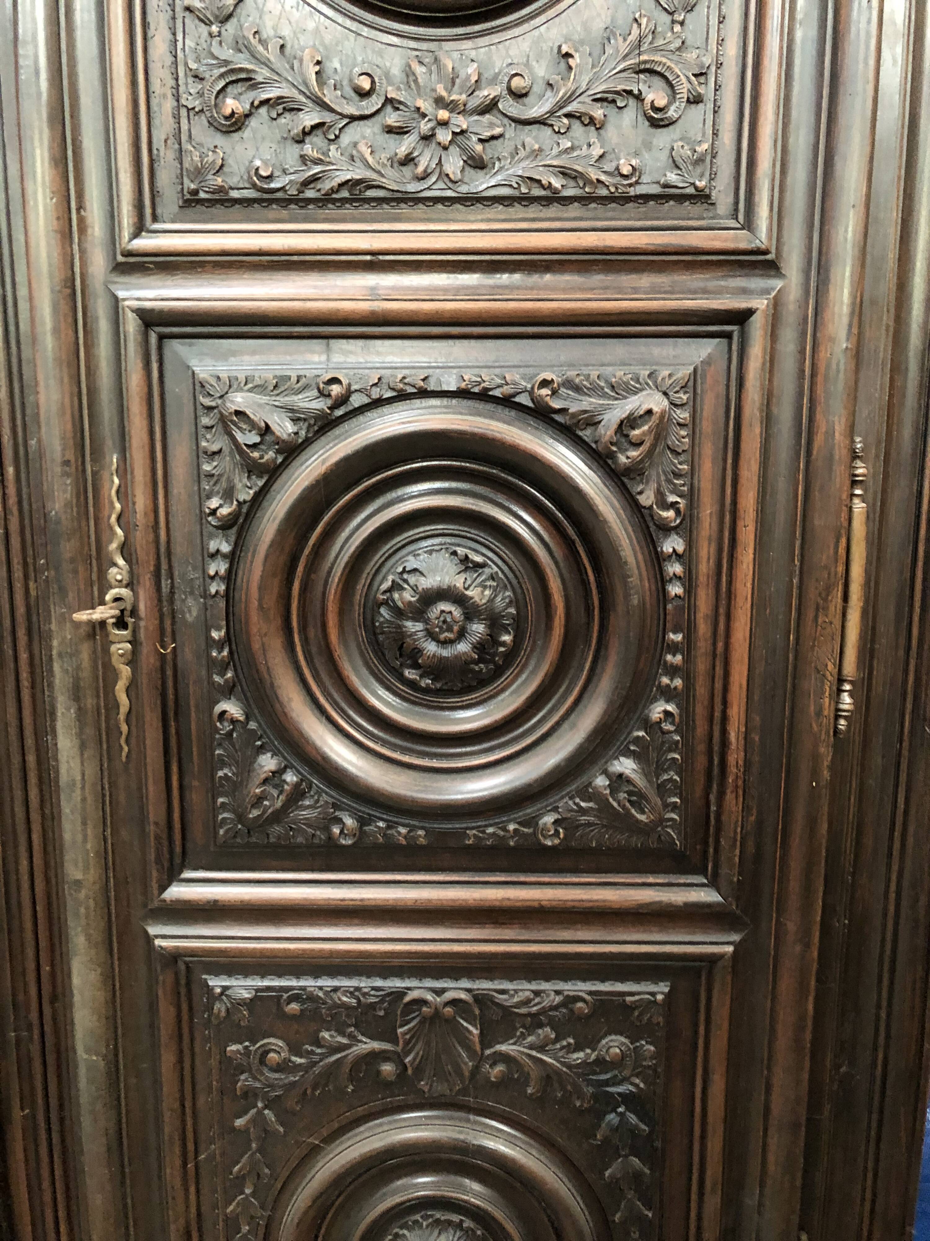 Antique Louis XIII armoire in solid walnut with carved doors