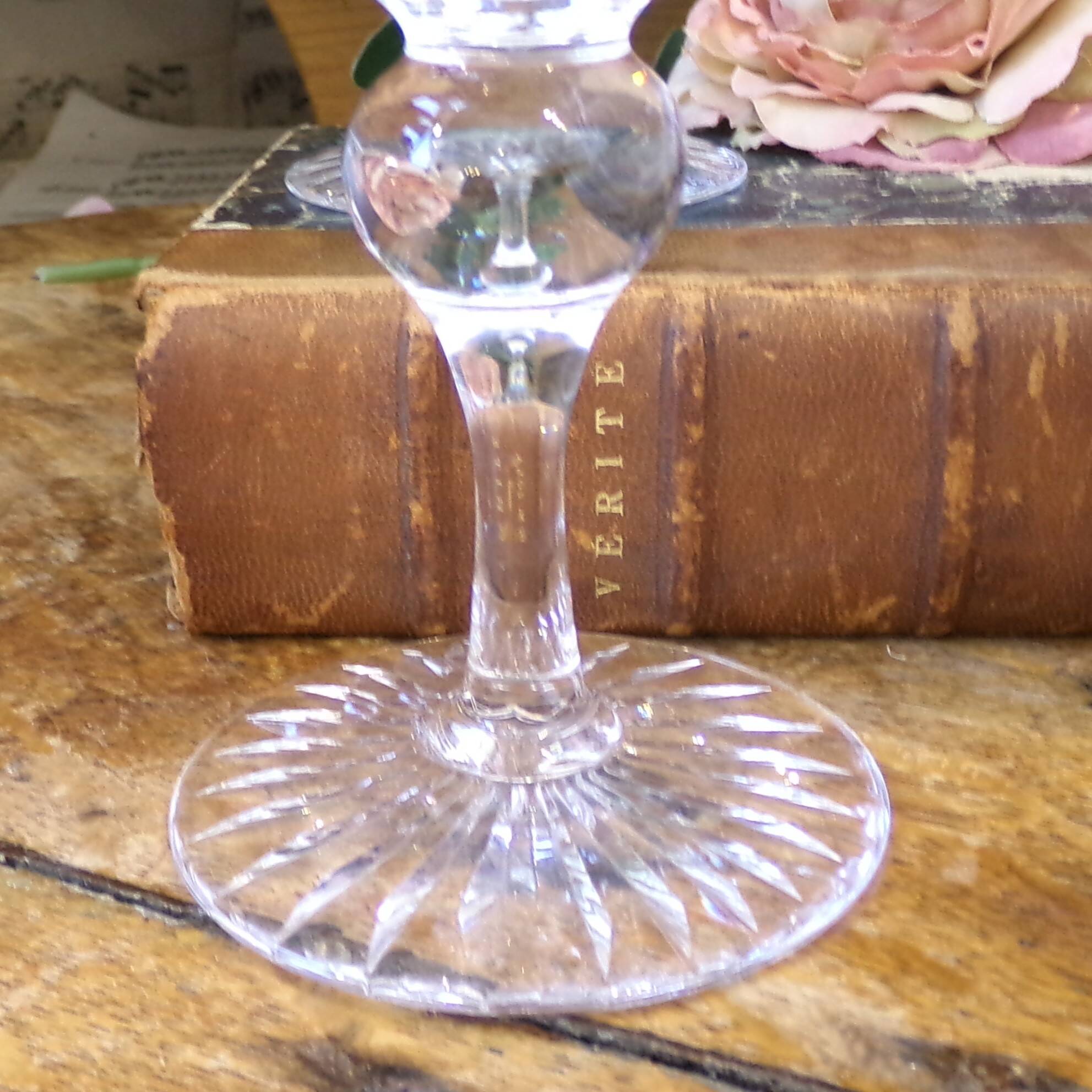 Cut crystal white wine glasses with a slender baluster-shaped stem.