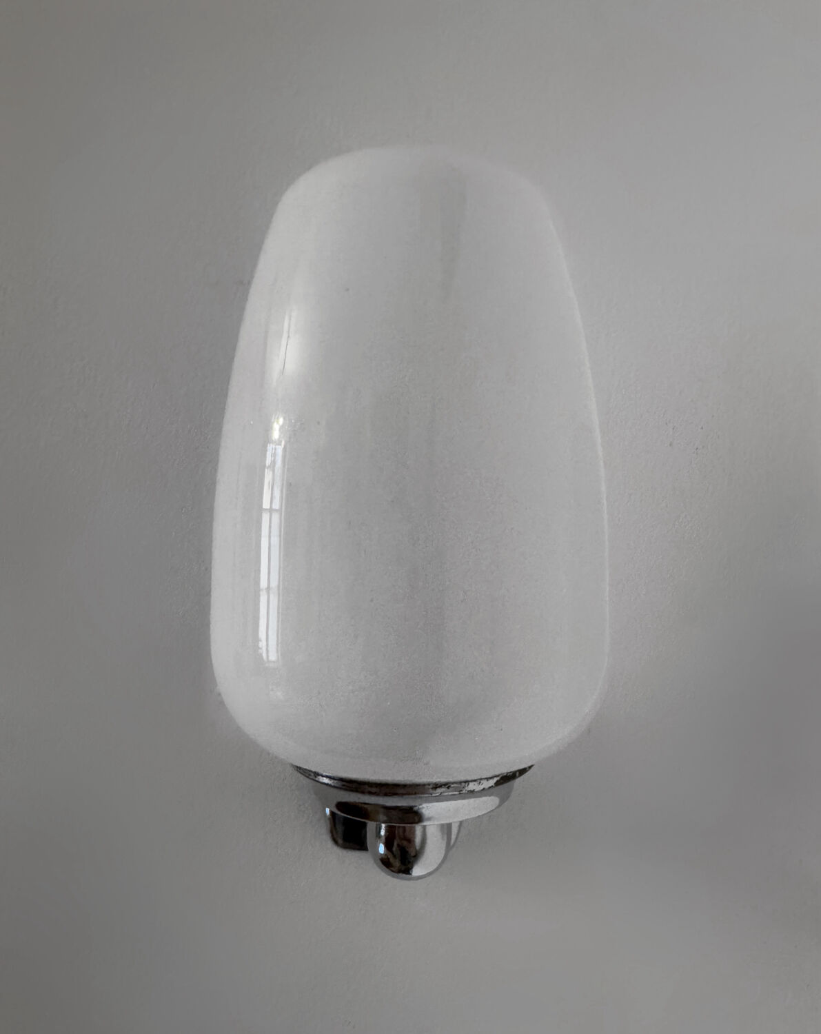 Chrome and opaline wall lights from the 70s.