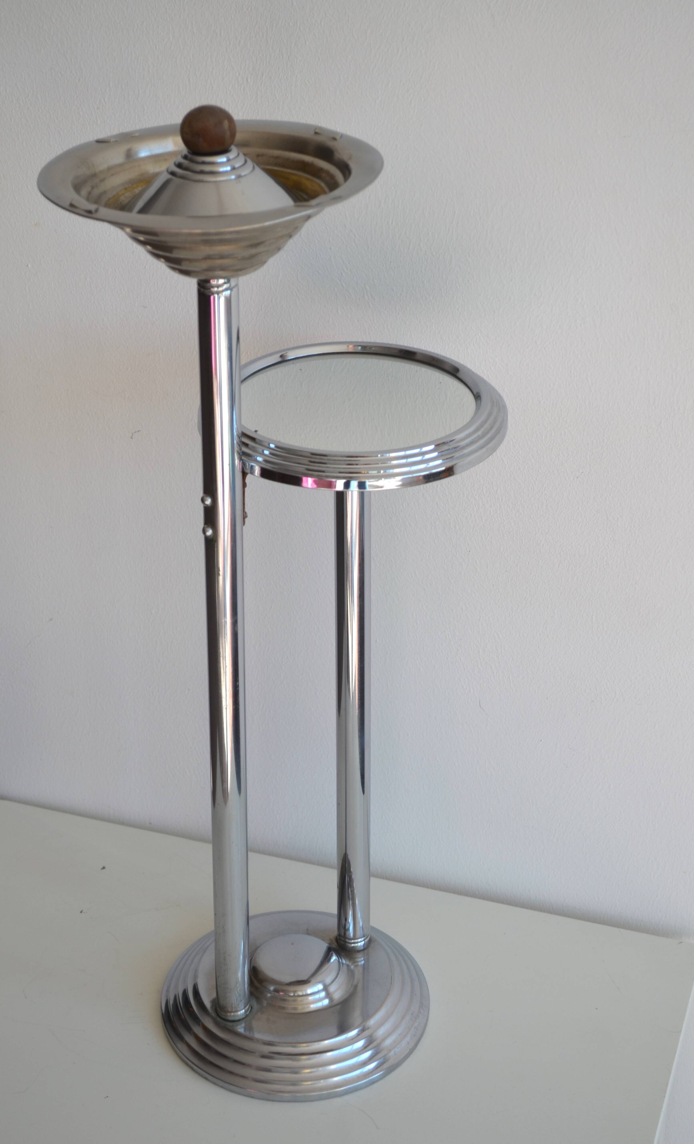 Ashtray and shelf on chrome metal stand.