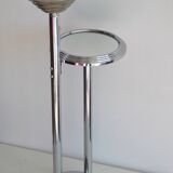 Ashtray and shelf on chrome metal stand.