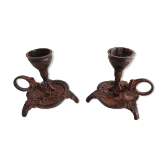 Pair of bronze hand-held candlesticks