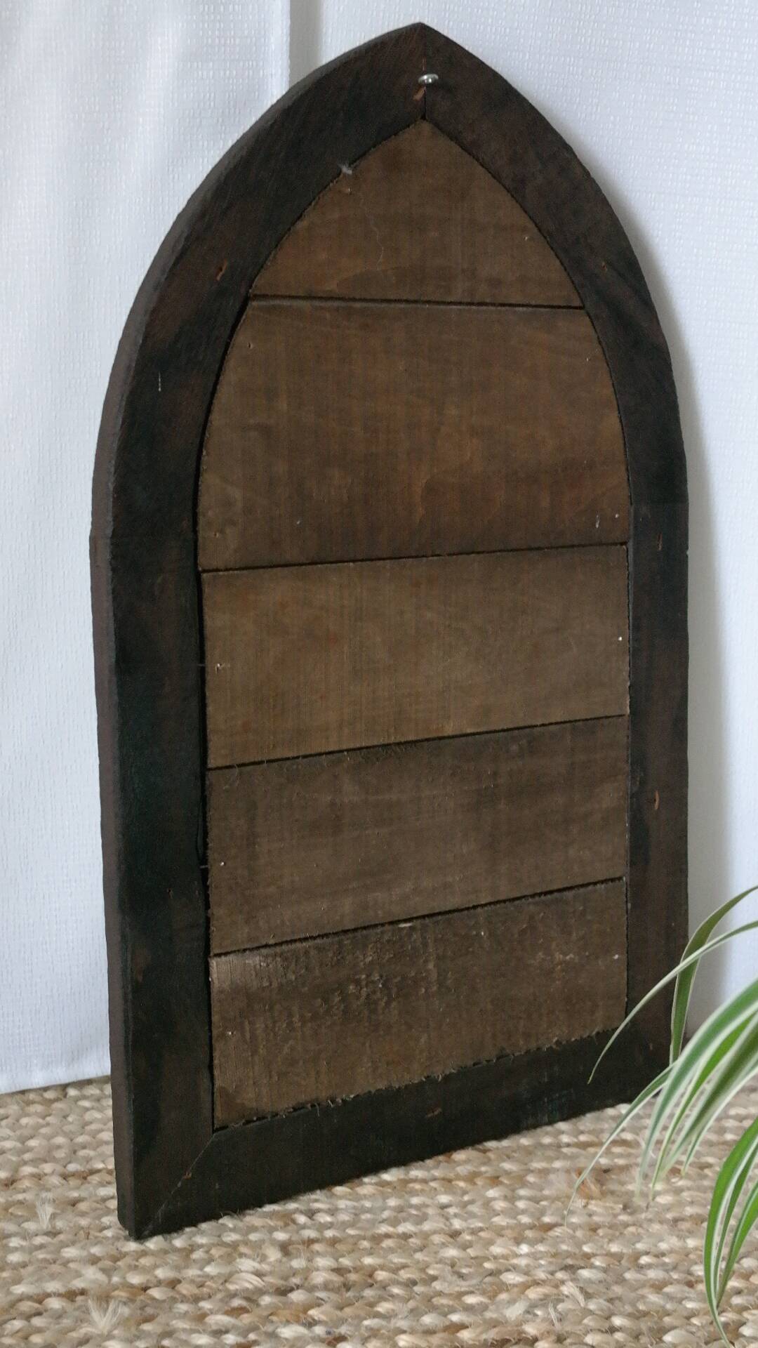 Old handcrafted Gothic style wooden mirror