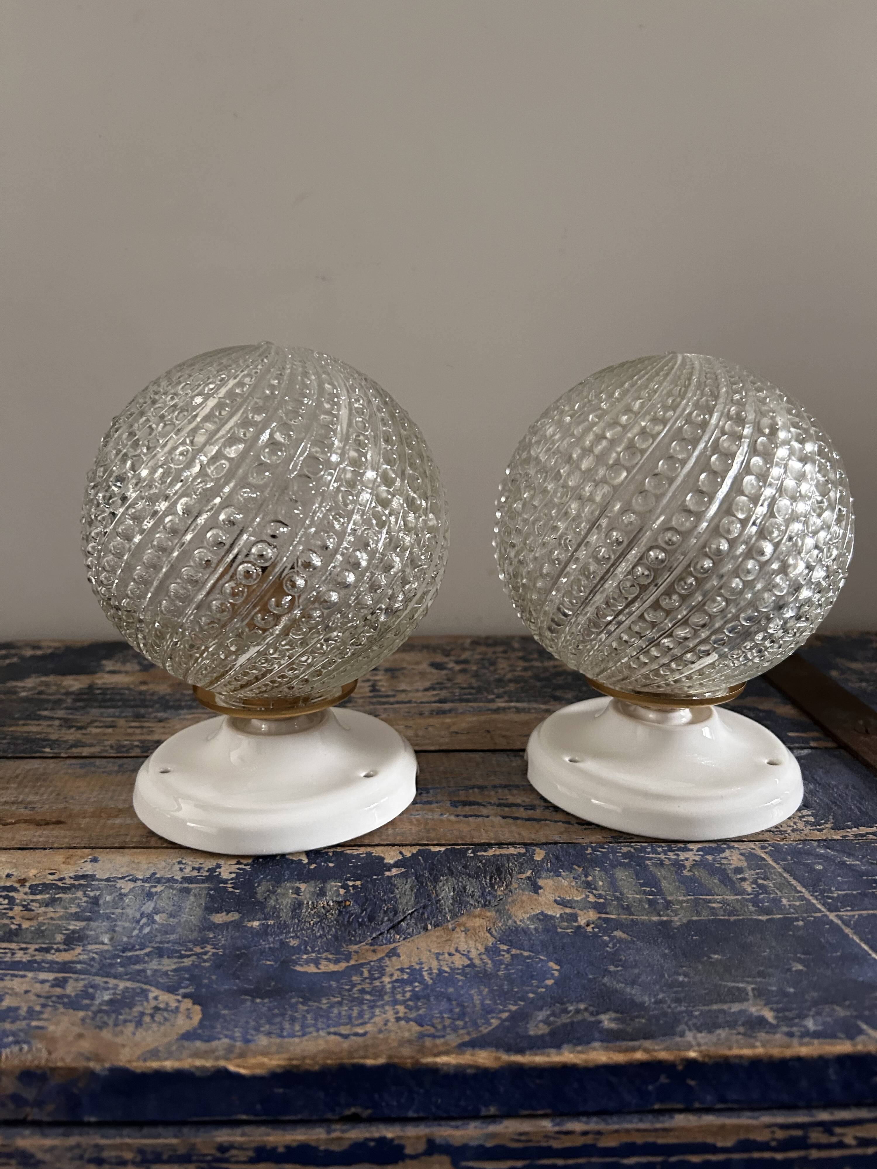 Set of two chiseled glass globe wall lights
