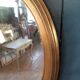 Pair of golden oval mirrors