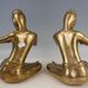 Pair of bookends in brass, flute players