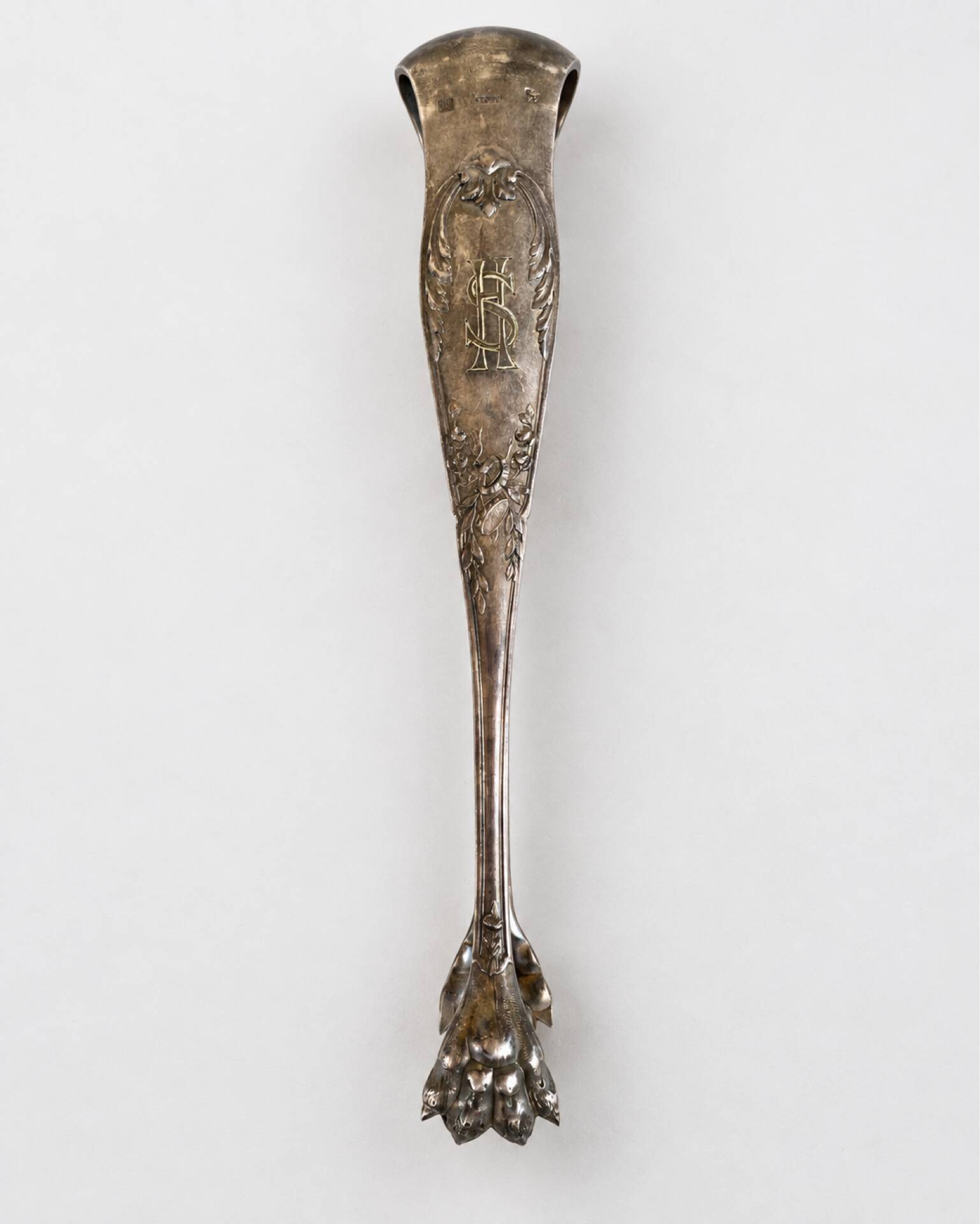 Antique silver-plated sugar tongs SFAM with monogram.