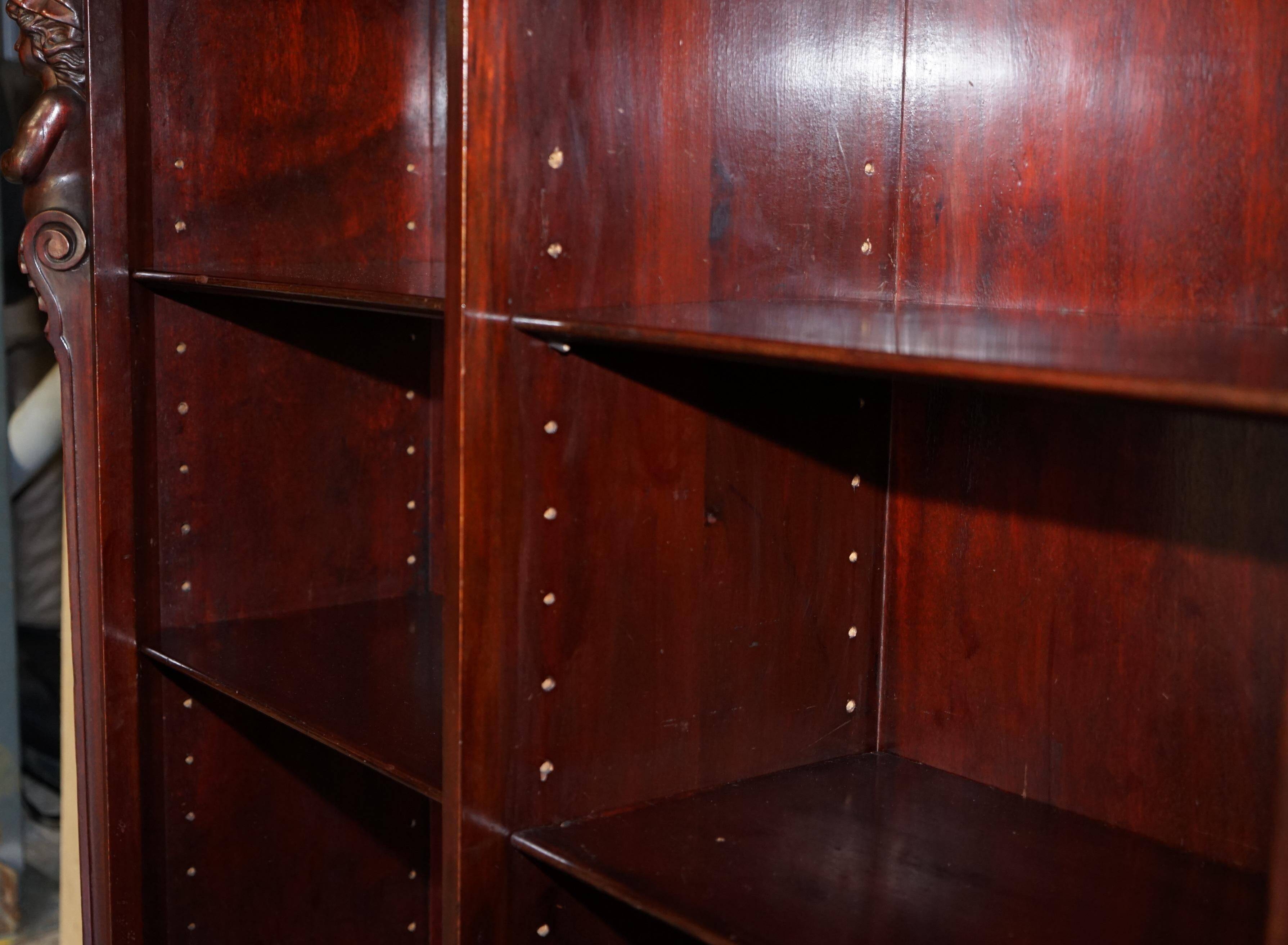 Hand-carved library circa 1900 in hardwood with Hermes statues.