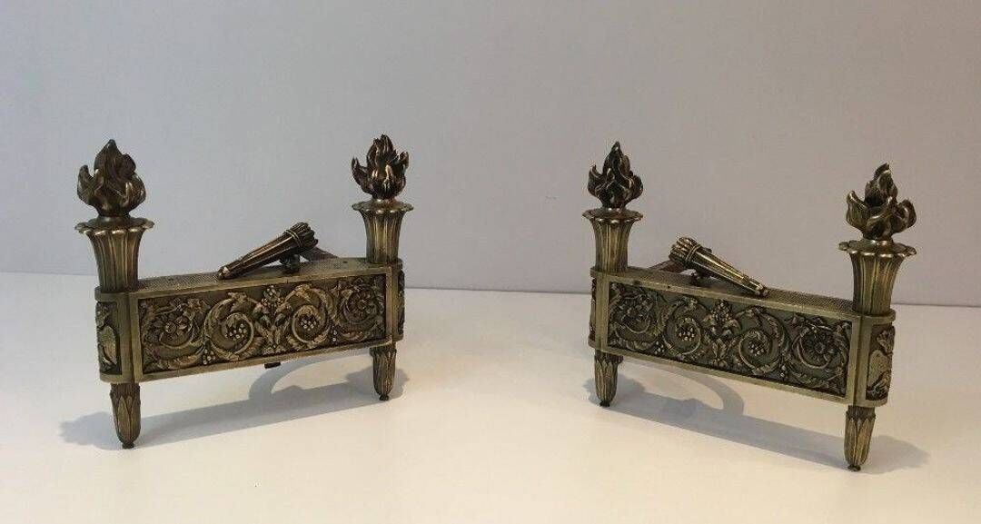 Pair of Empire Period Chenets in Chiselled Bronze with Torches and Leaf Frieze
