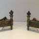 Pair of Empire Period Chenets in Chiselled Bronze with Torches and Leaf Frieze