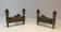 Pair of Empire Period Chenets in Chiselled Bronze with Torches and Leaf Frieze