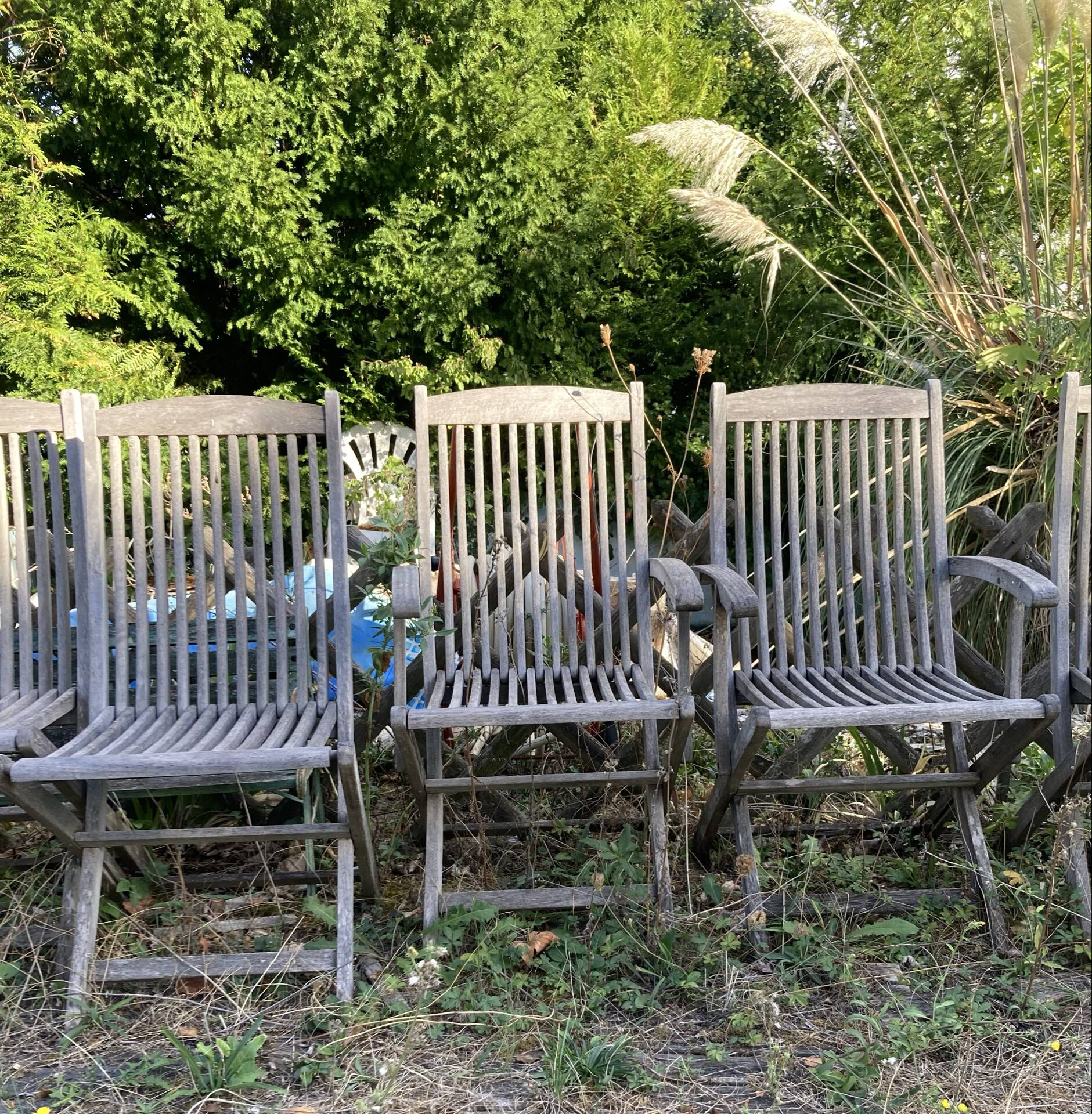 Folding garden chairs and armchairs in River Han dowelled teak.
