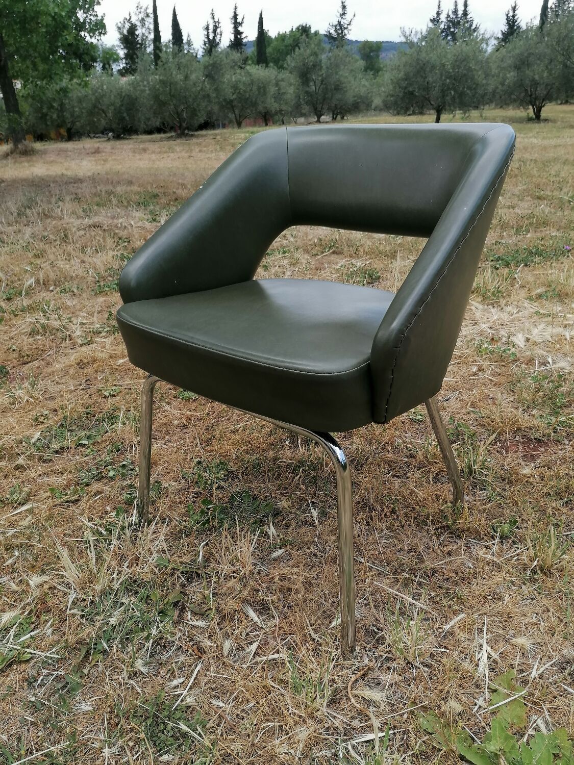Vintage conference armchair in green skai Roset SNA