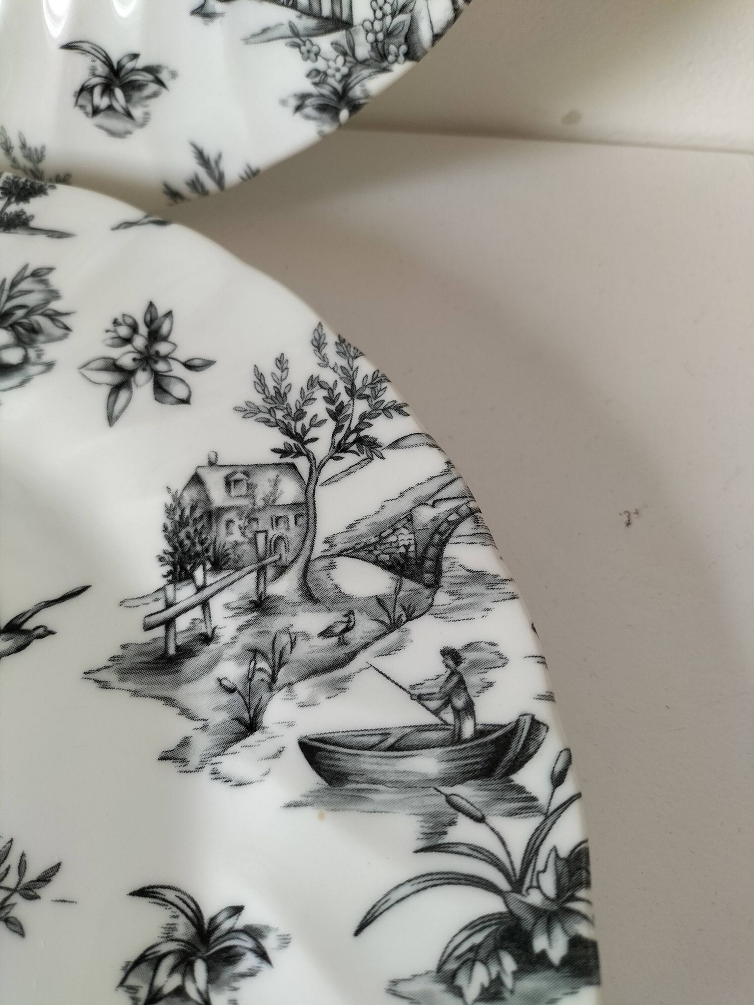 Set of black and white plates in the style of toile de Jouy.