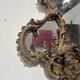 Mirror with a decorative frame featuring a four-light wall sconce, 19th century.
