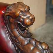 Victorian Chesterfield leather sofa with carved lion heads.