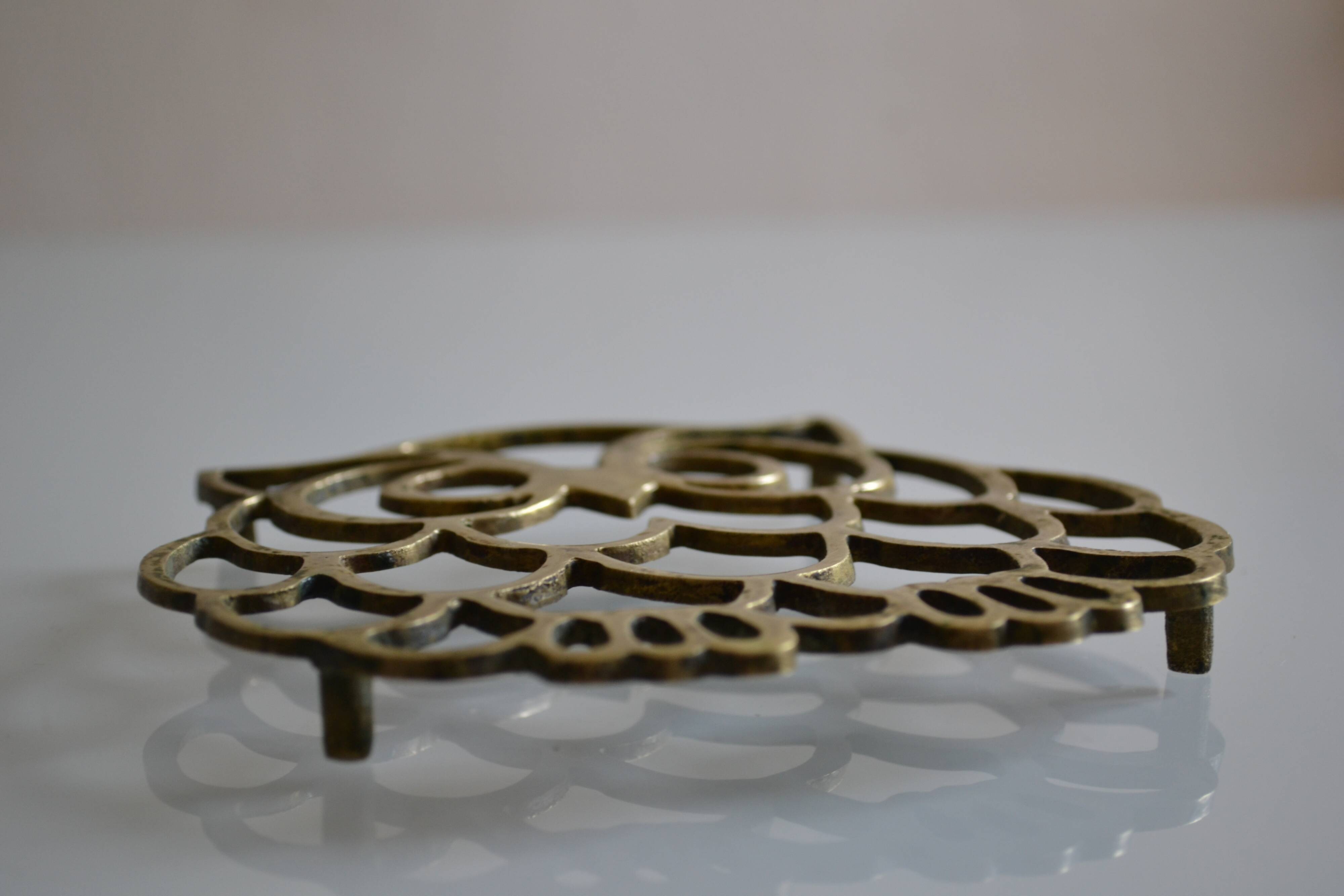 Vintage openwork brass trivet in the shape of an owl or owl