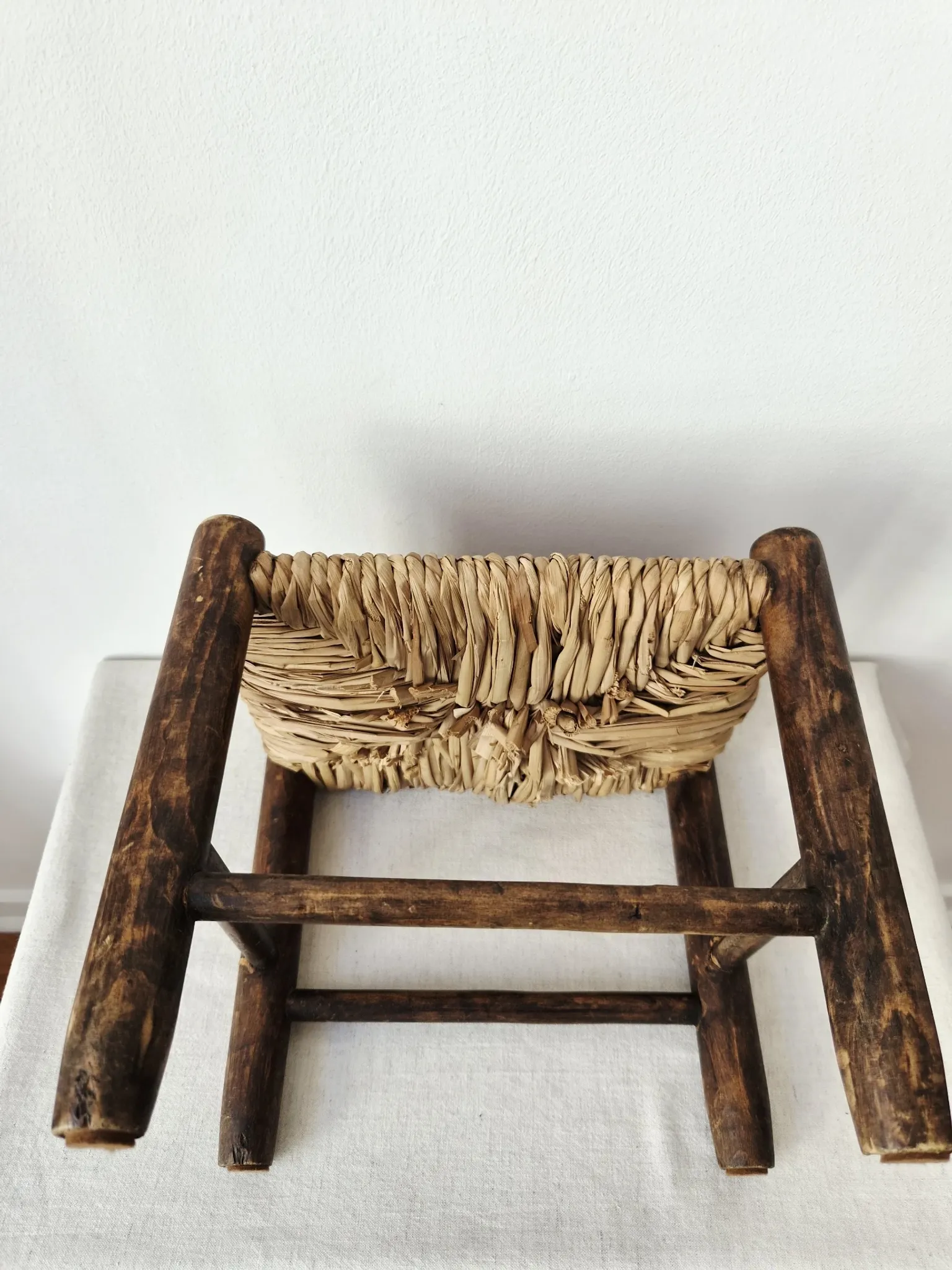Small rustic vintage wooden and straw stool -