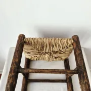 Small rustic vintage wooden and straw stool -