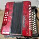 Red Aidi R accordion in his suitcase