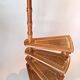 Library spiral staircase in beech and brown leather.
