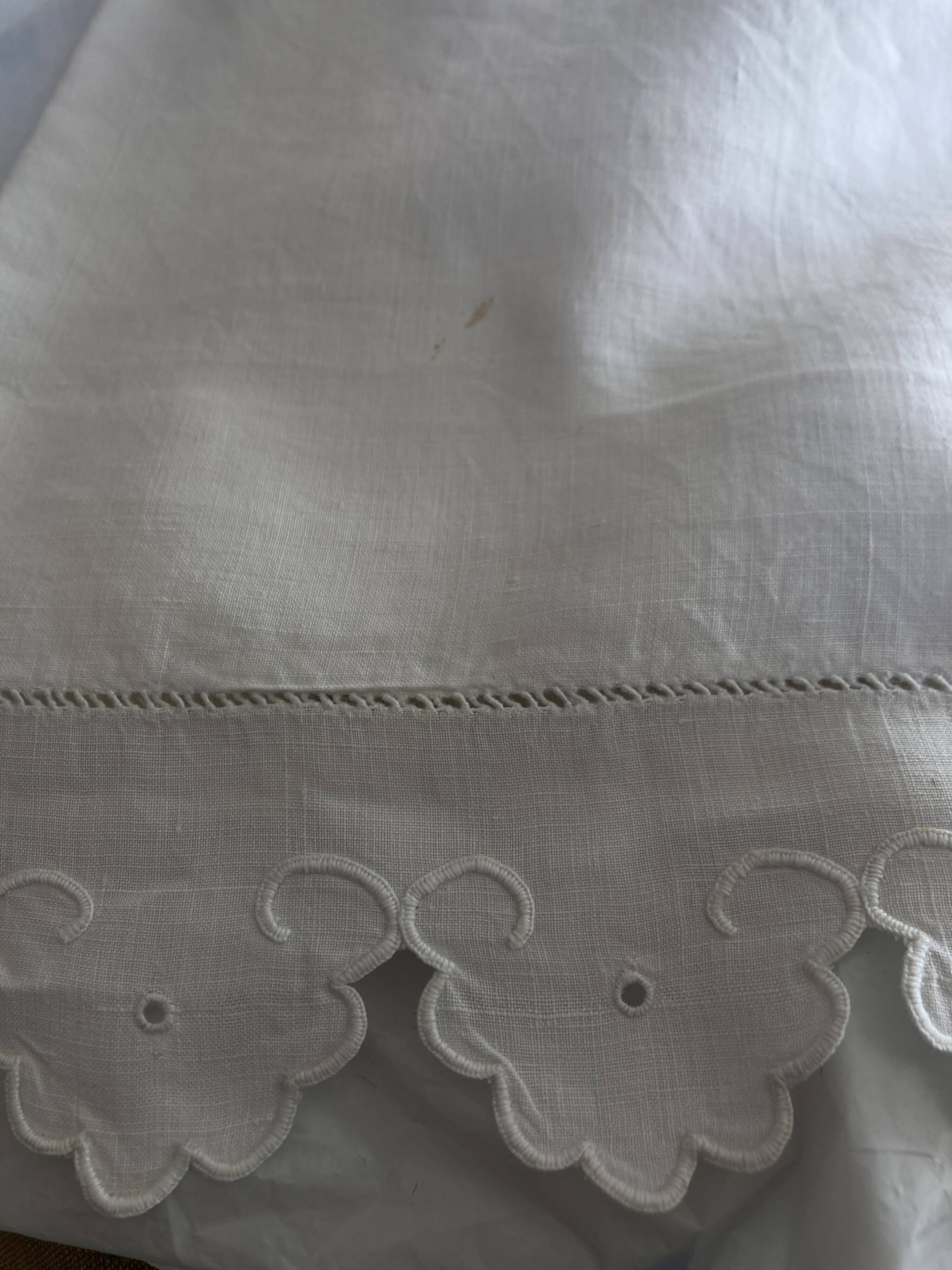 Pair of 19th century linen thread pillowcases embroidered with scallops