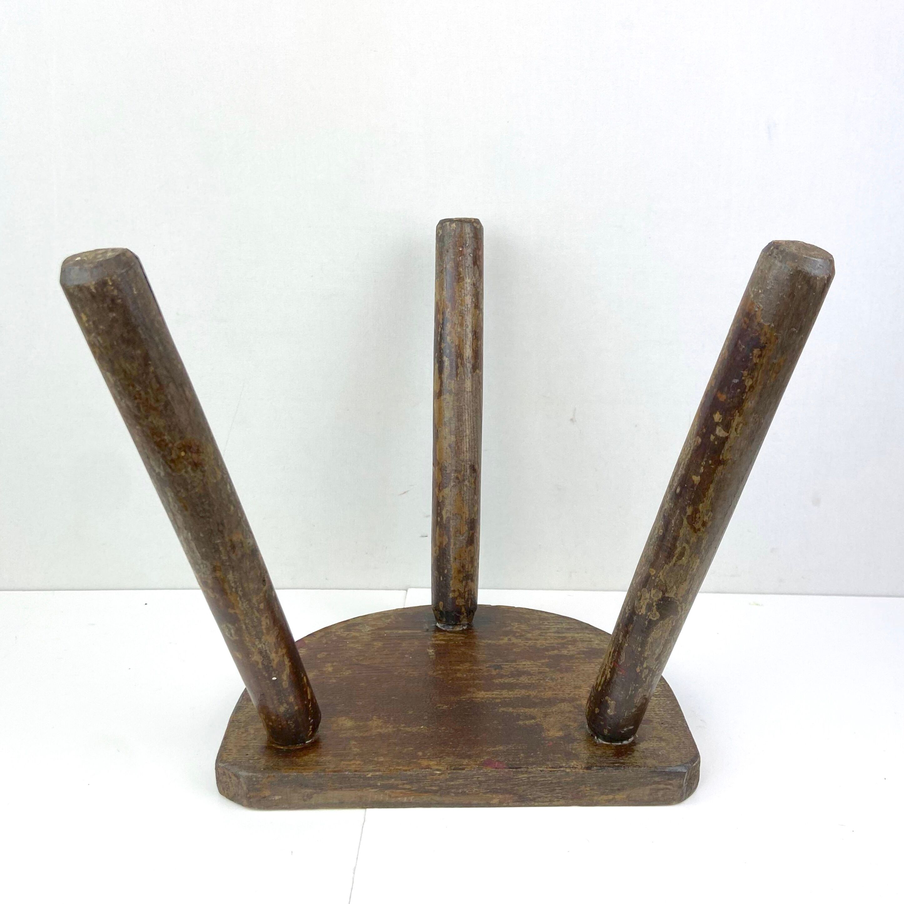 Ancient tripod milking stool - field theme, nature