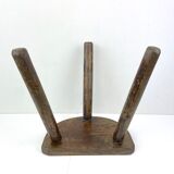 Ancient tripod milking stool - field theme, nature