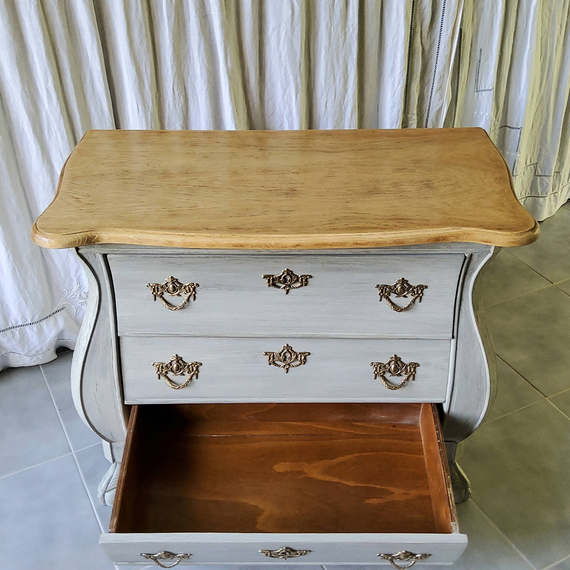 Curved patinated chest of drawers