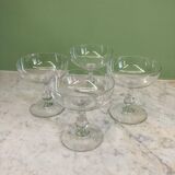 4 Baccarat crystal champagne coupes in a gondola shape.