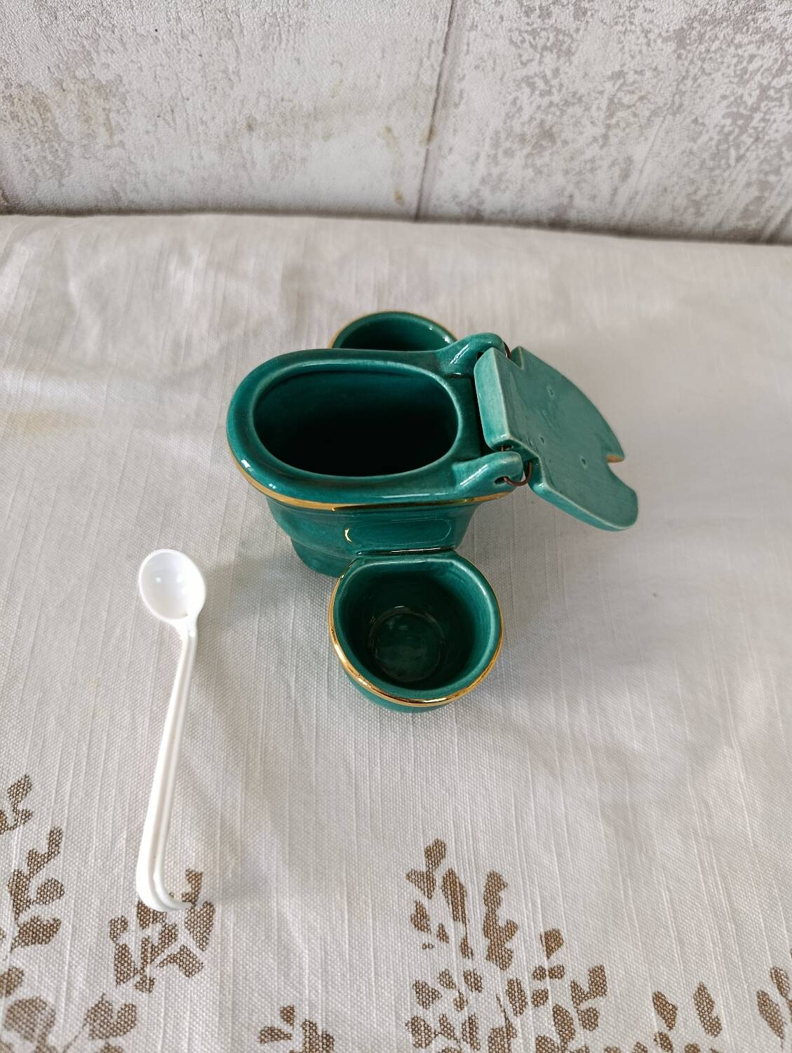 Mustard and salt pepper shaker in the shape of a toilet.