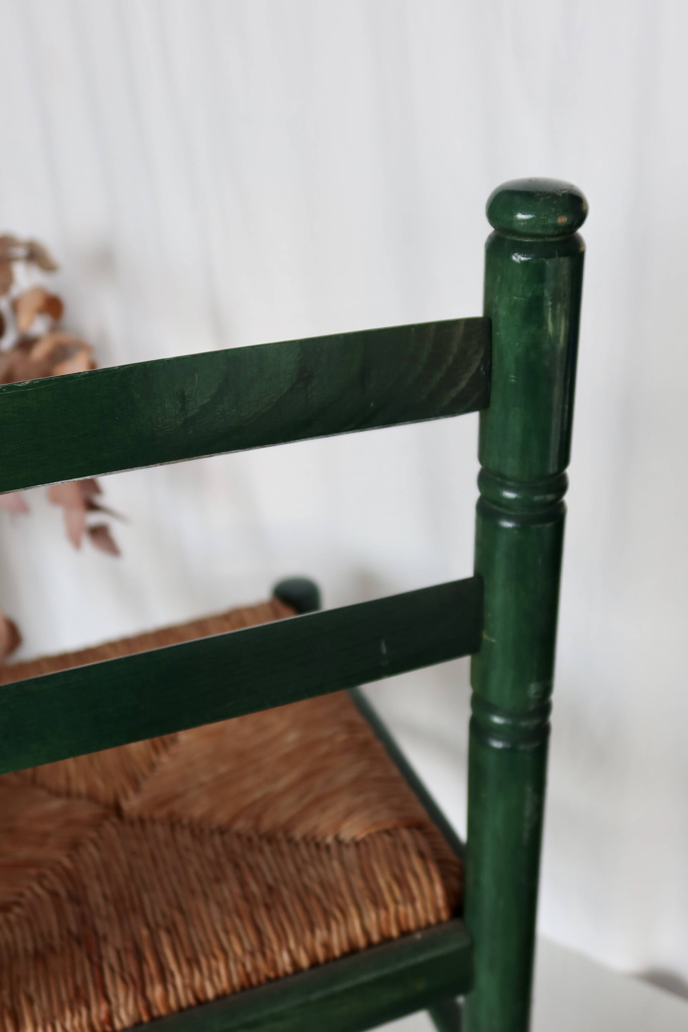 Vintage children's chair in green wood with a woven straw seat